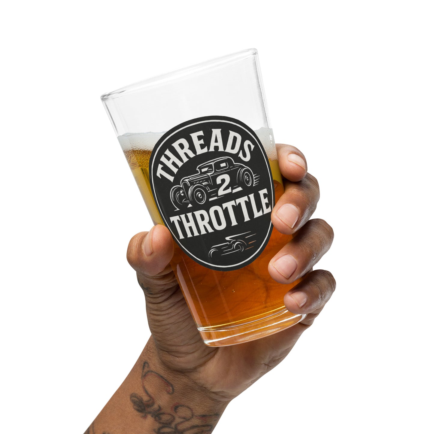 Hot rod pint glass with vintage Threads 2 Throttle logo held in hand with beer